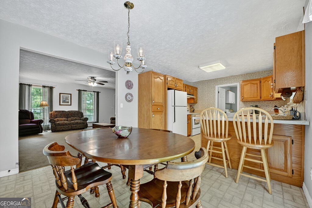 1362 Cherry Log Street Cherry Log, GA 30522 - Photo 11 of 55 a dining room with furniture a chandelier and wooden floor