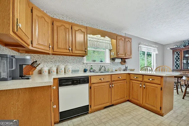 a kitchen with stainless steel appliances granite countertop a sink stove and cabinets