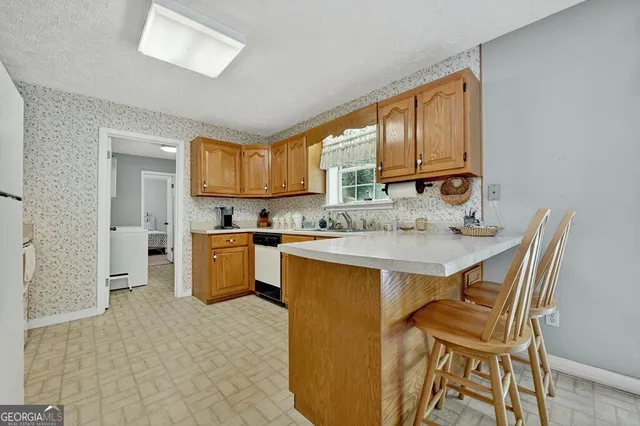 a kitchen with a sink cabinets and window