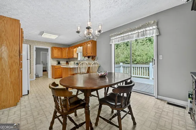 a view of a dining room with furniture window and outside view