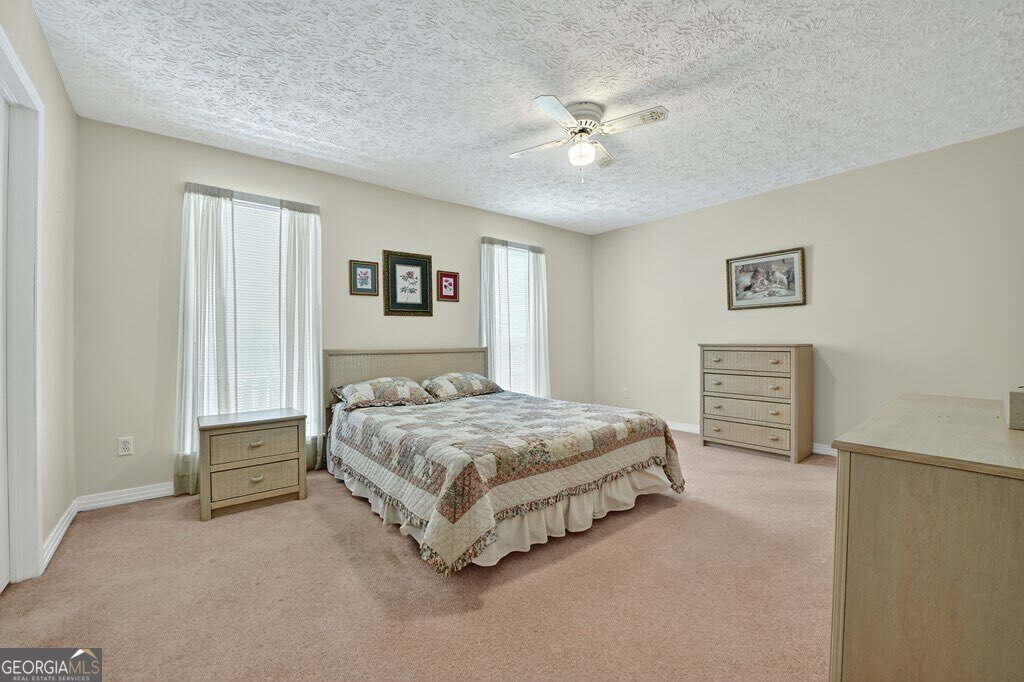 1362 Cherry Log Street Cherry Log, GA 30522 - Photo 19 of 55 a spacious bedroom with a bed and a chandelier