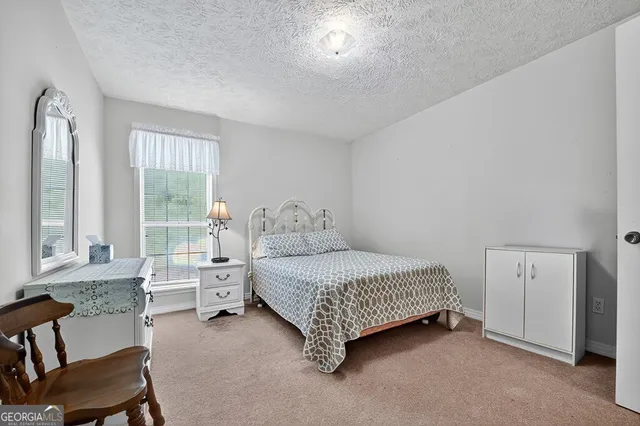 a bed room with a bed and a chair