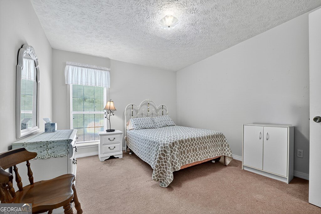 1362 Cherry Log Street Cherry Log, GA 30522 - Photo 22 of 55 a bed room with a bed and a chair