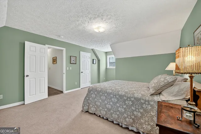 a bedroom with a bed and a lamp