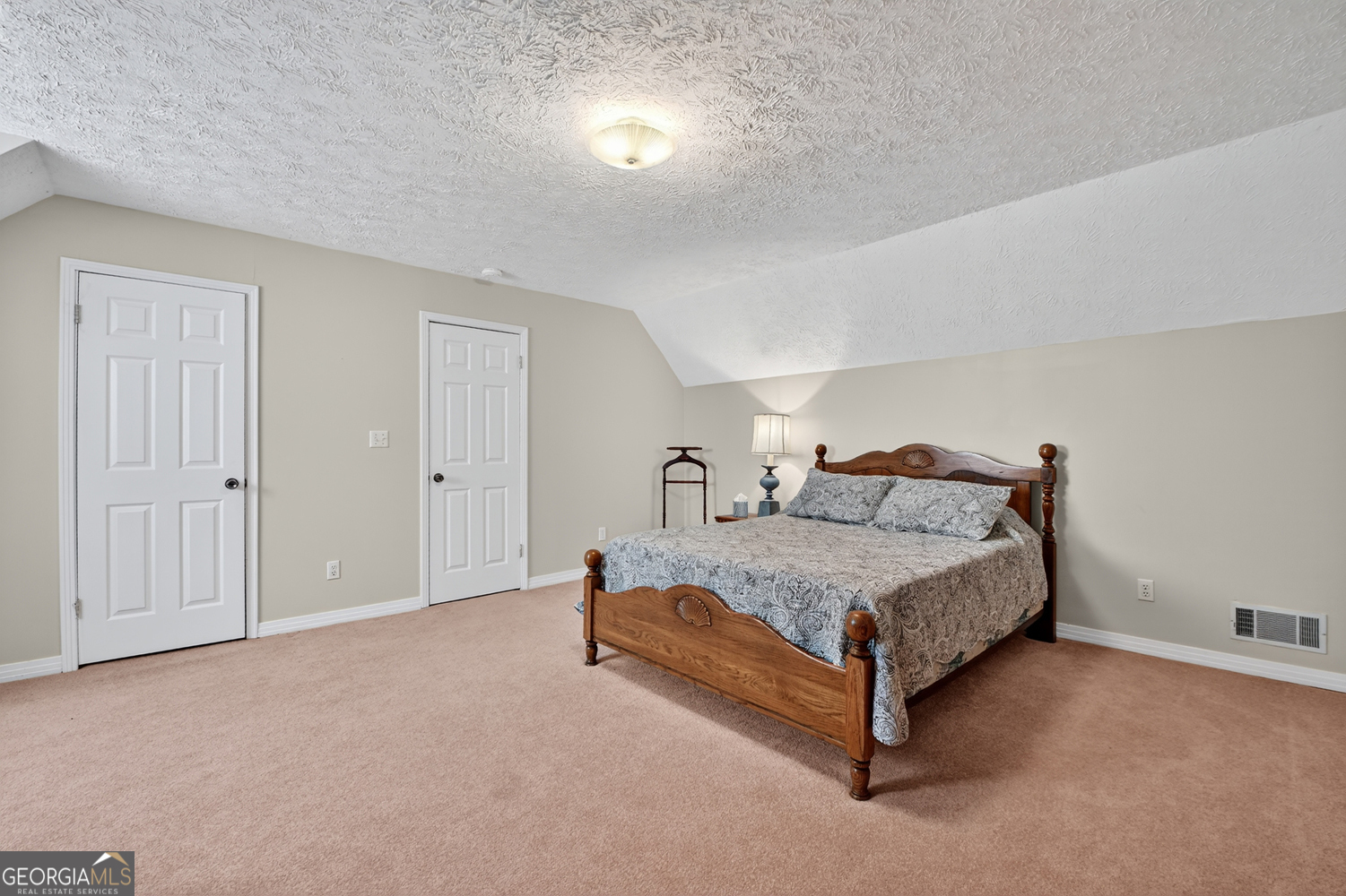 1362 Cherry Log Street Cherry Log, GA 30522 - Photo 25 of 55 a spacious bedroom with a bed and a lamp