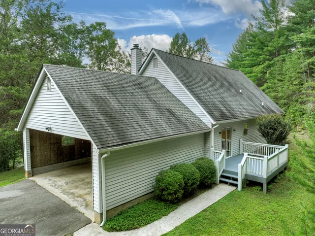 a backyard of a house with table and chairs