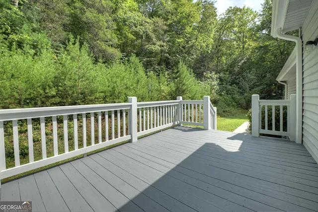 a view of balcony with wooden floor and outdoor seating