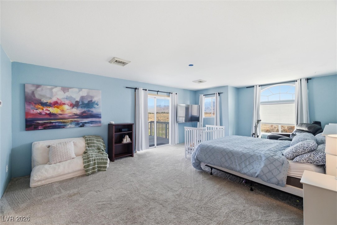 2570 East Kellogg Road Pahrump, NV 89048 - Photo 26 of 60 Large primary suite with access to outside deck. En suite and large walk-in closet.