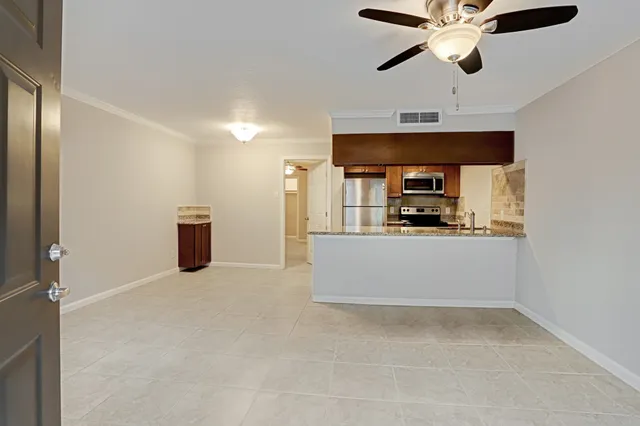 a kitchen with stainless steel appliances a refrigerator and a microwave