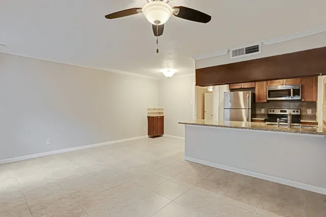 a view of an empty room with windows