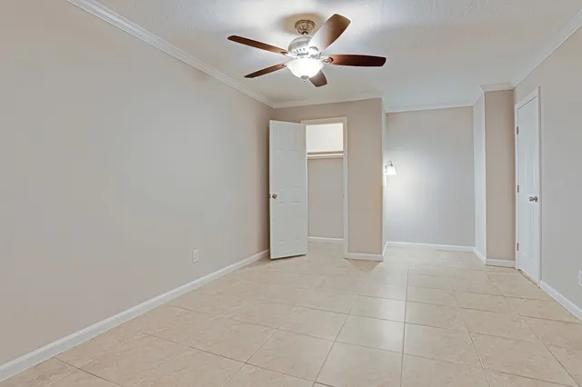 a view of a patio with couches and table and chairs with plants and trees