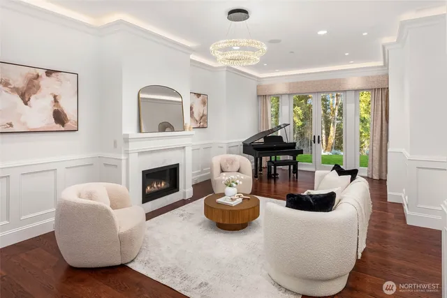 a living room with furniture a fireplace and a large window