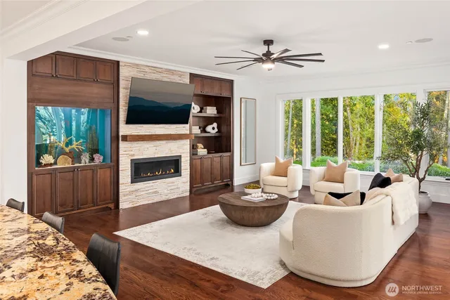 a living room with furniture a fireplace and a flat screen tv
