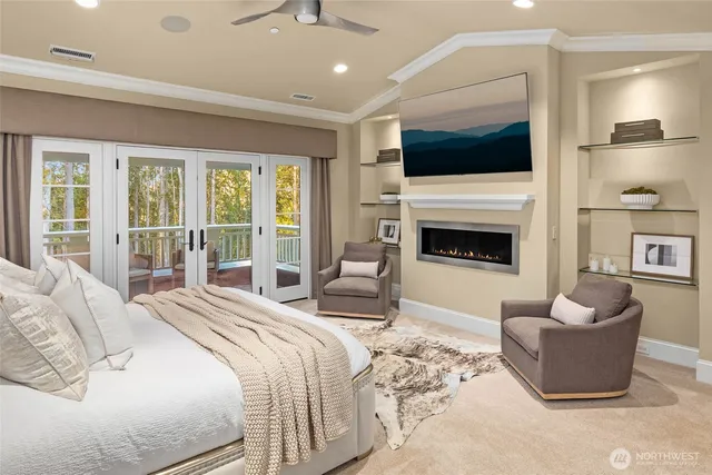 a bedroom with furniture a flat screen tv and a fireplace