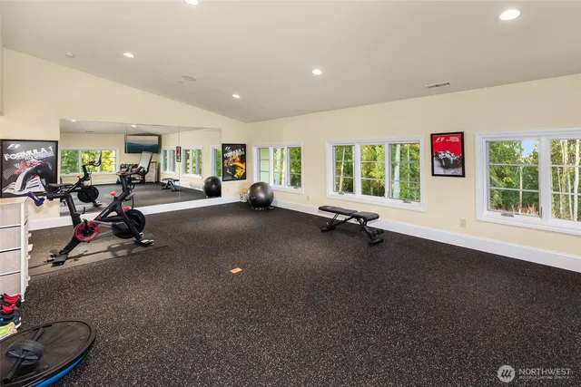 a living room with furniture a flat screen tv and a large window