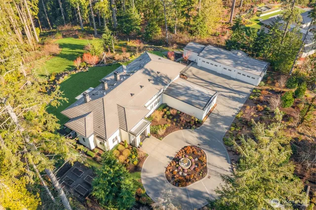 an aerial view of a house with a yard basket ball court and outdoor seating