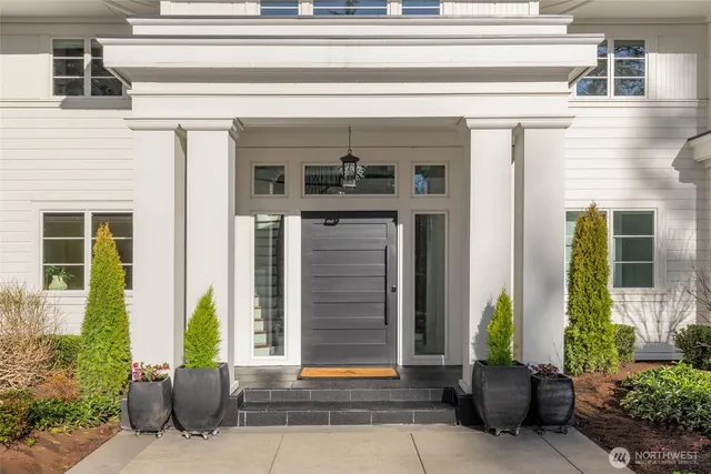 a front view of a house with potted plants