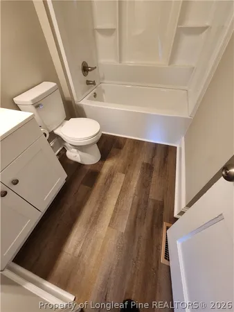 a bathroom with a toilet and a bathtub