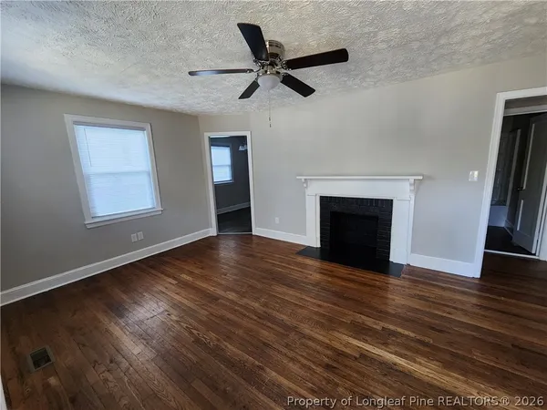 wooden floor in an empty room with a fireplace
