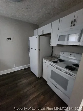 a kitchen with a stove and a refrigerator