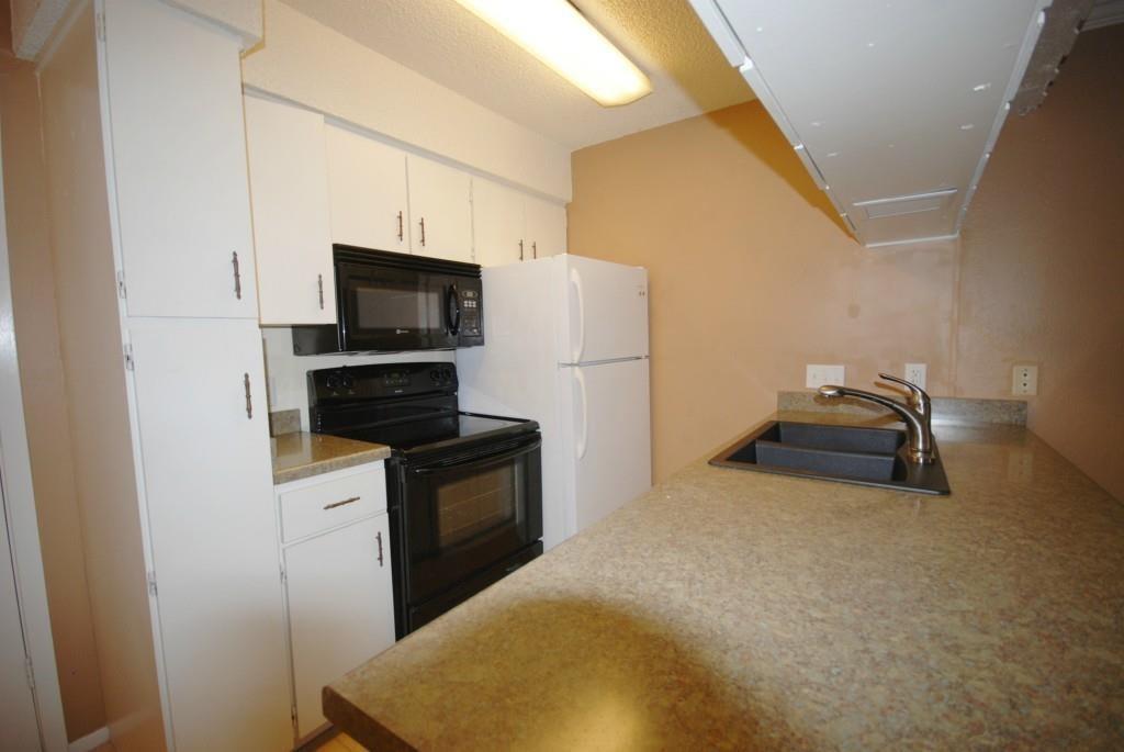 910 Duncan Lane, Unit 11 Austin, TX 78705 - Photo 1 of 5 a kitchen with stainless steel appliances kitchen island a stove a refrigerator and a refrigerator