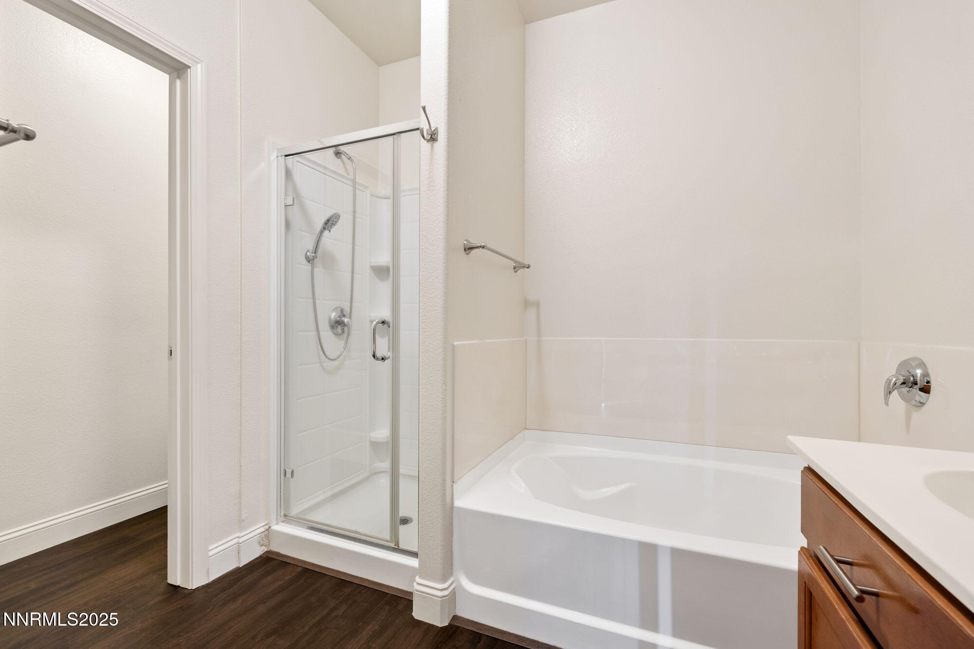 1325 South Meadows Parkway, Unit 224 Reno, NV 89521 - Photo 11 of 29 a white bath tub sitting next to a shower