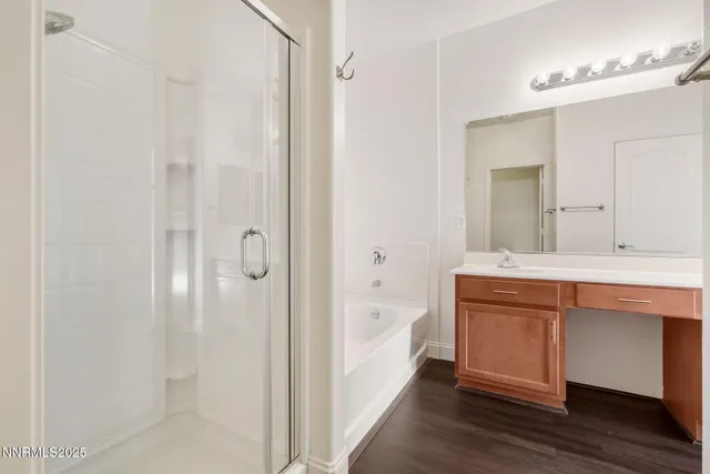 a bathroom with a tub sink and mirror