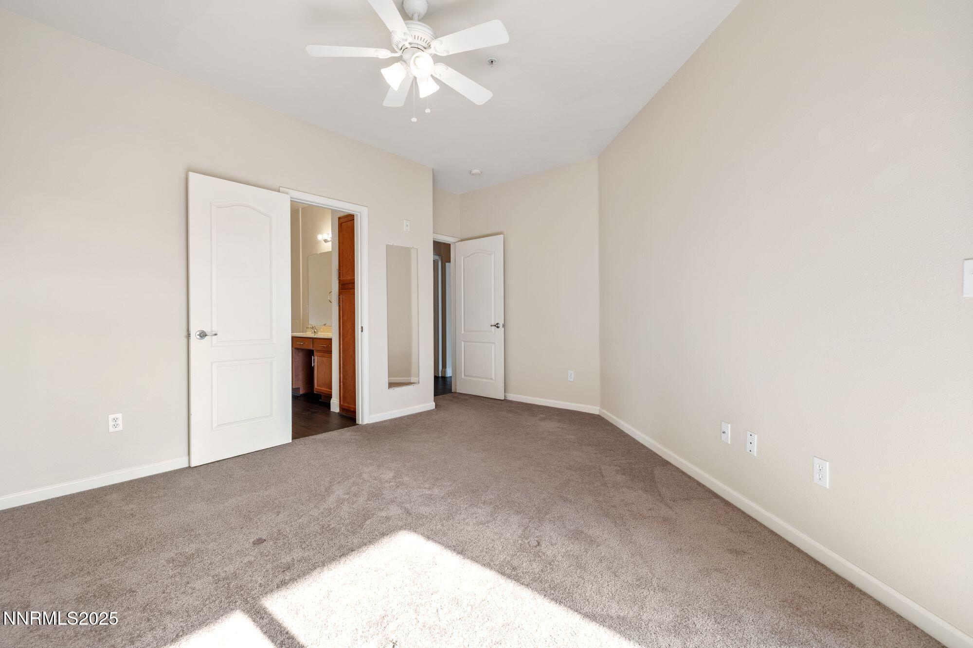 1325 South Meadows Parkway, Unit 224 Reno, NV 89521 - Photo 14 of 29 an empty room with a ceiling fan and a window