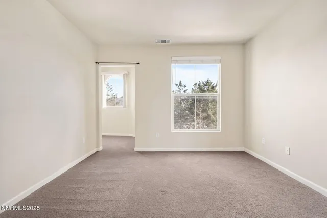 an empty room with windows and closet