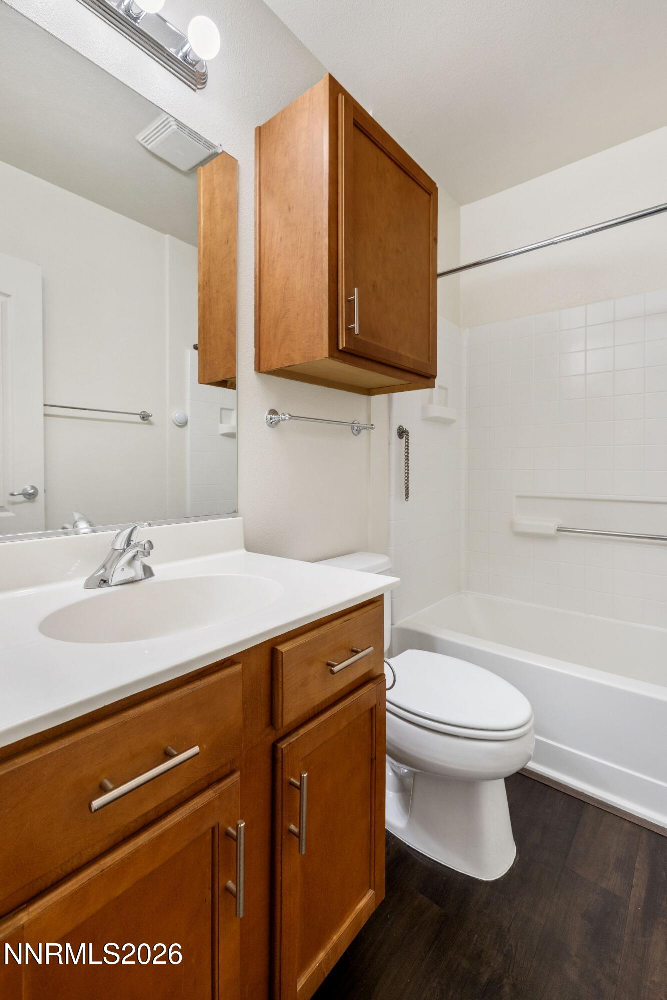 1325 South Meadows Parkway, Unit 224 Reno, NV 89521 - Photo 20 of 29 a bathroom with a sink a toilet and mirror