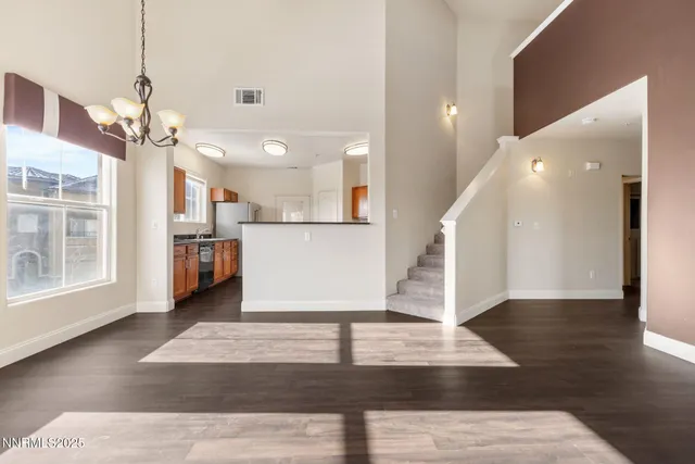 a view of a house with wooden floor and a kitchen