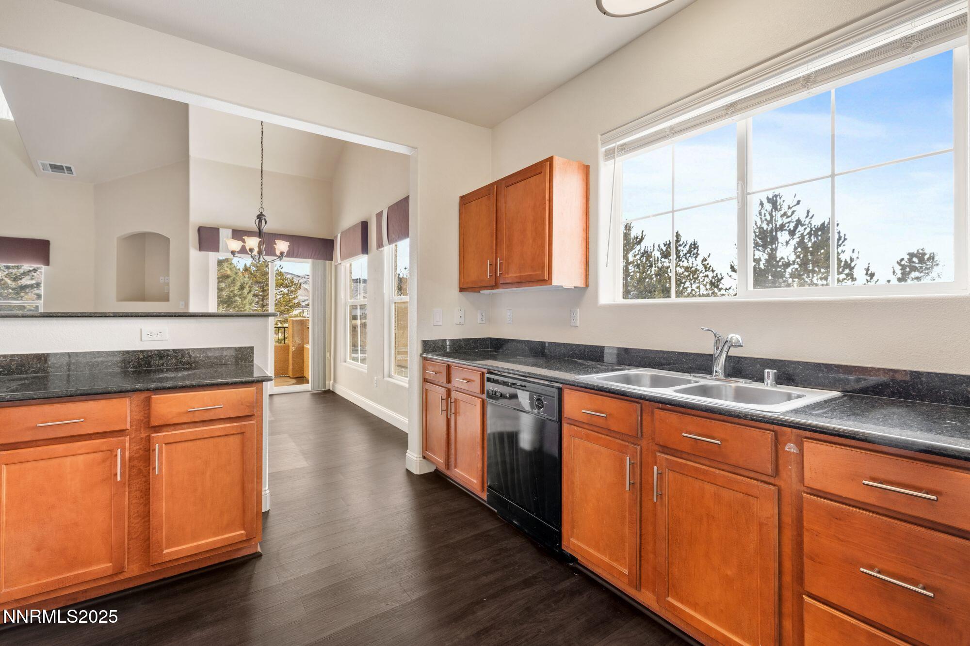 1325 South Meadows Parkway, Unit 224 Reno, NV 89521 - Photo 5 of 29 a kitchen with stainless steel appliances granite countertop wooden cabinets a stove and a sink