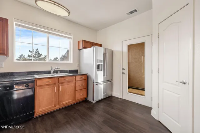 a kitchen with stainless steel appliances granite countertop a refrigerator and a stove top oven