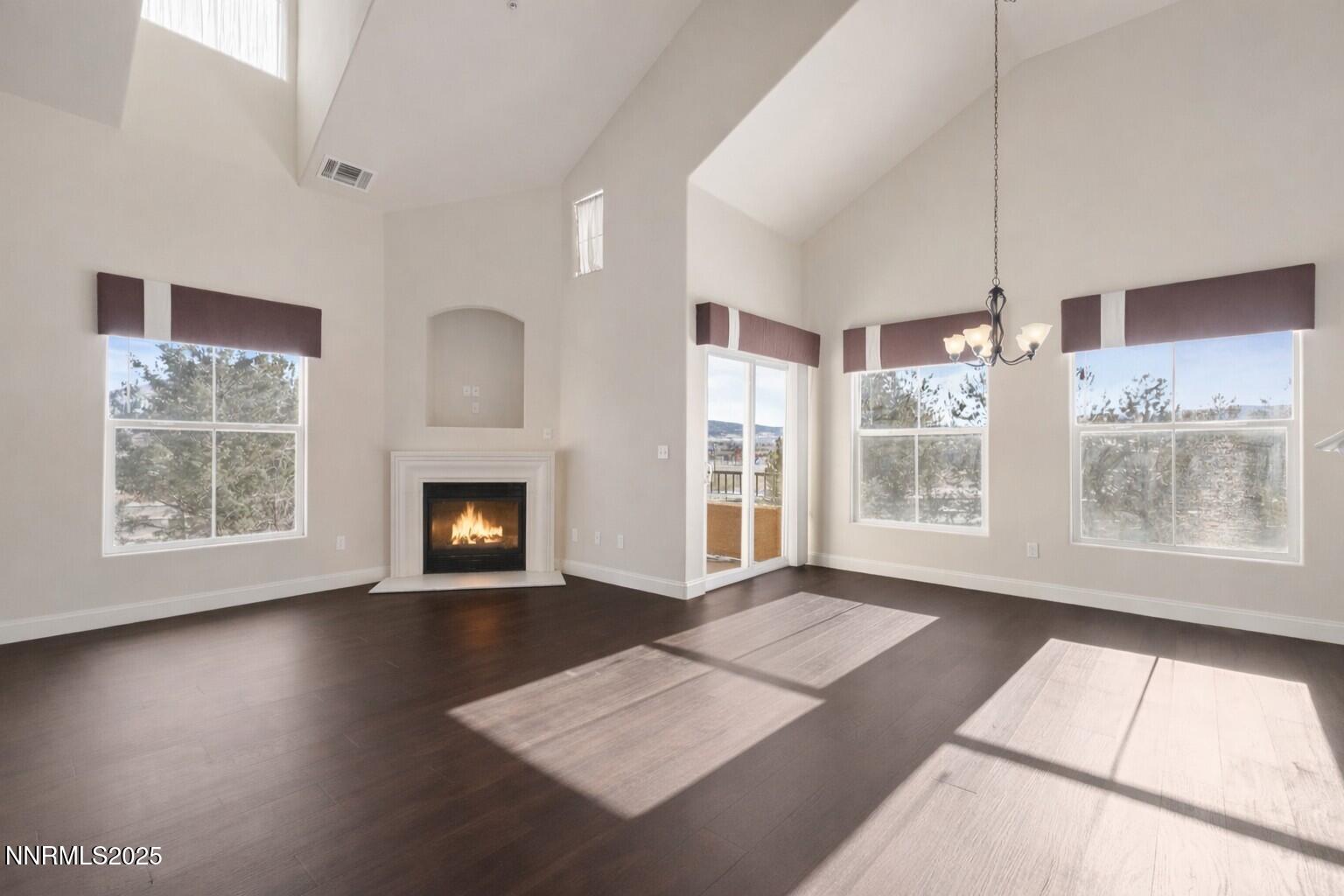 1325 South Meadows Parkway, Unit 224 Reno, NV 89521 - Photo 7 of 29 a view of an empty room with a window and wooden floor