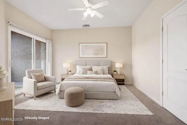 a bedroom with a white bed and a couch