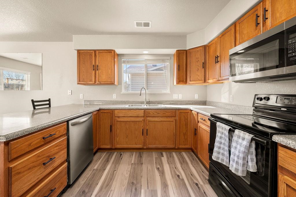 312 Catkin Street Fruita, CO 81521 - Photo 12 of 40 a kitchen with stainless steel appliances granite countertop a sink stove and cabinets