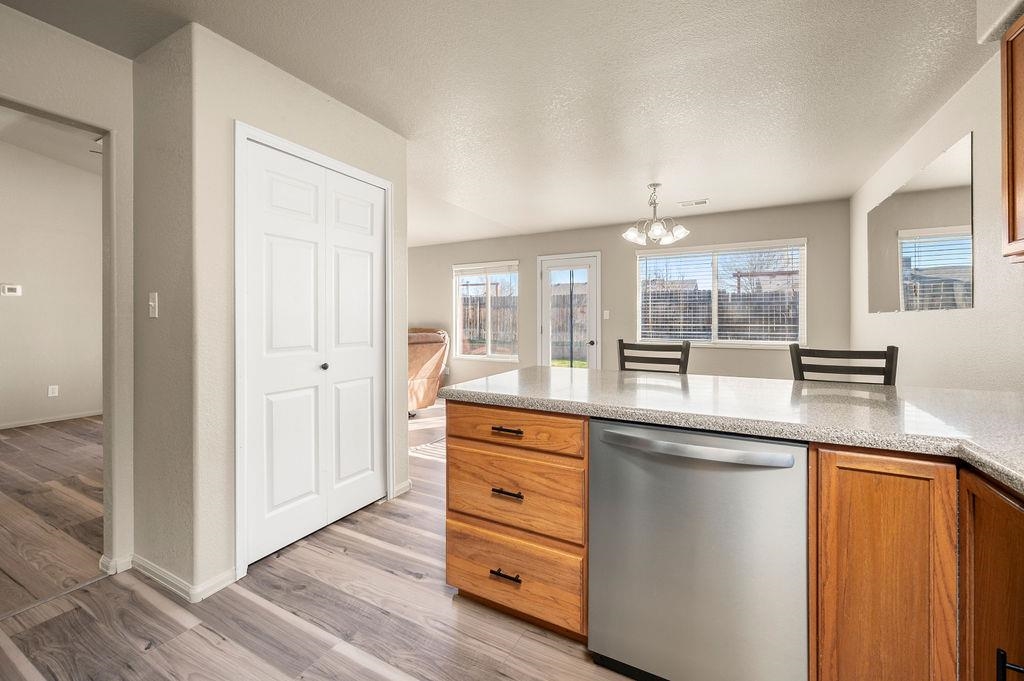 312 Catkin Street Fruita, CO 81521 - Photo 14 of 40 a kitchen with stainless steel appliances granite countertop a sink and wooden floor