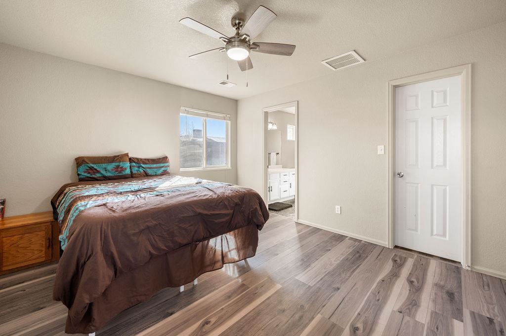 312 Catkin Street Fruita, CO 81521 - Photo 16 of 40 a bedroom with a bed and a ceiling fan