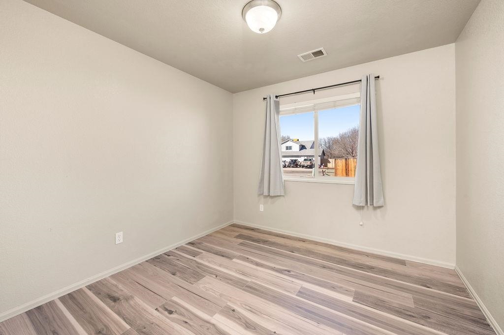 312 Catkin Street Fruita, CO 81521 - Photo 17 of 40 a view of a room with wooden floor and cabinet