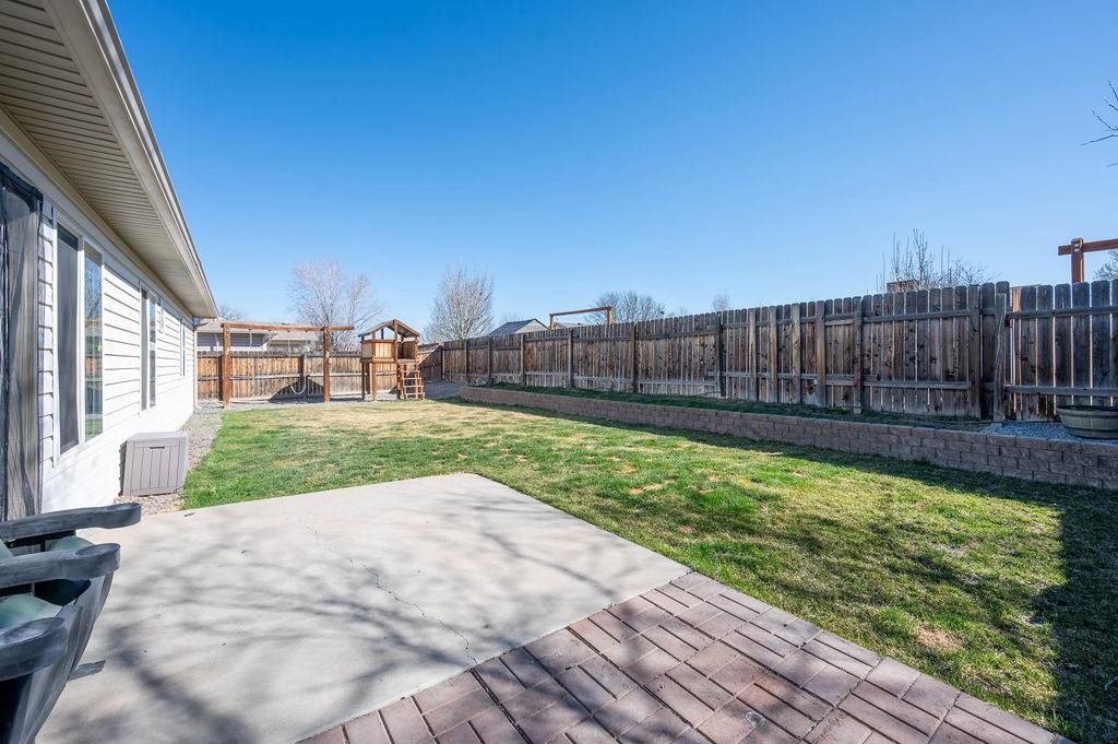 312 Catkin Street Fruita, CO 81521 - Photo 25 of 40 a view of a backyard with a garden and plants