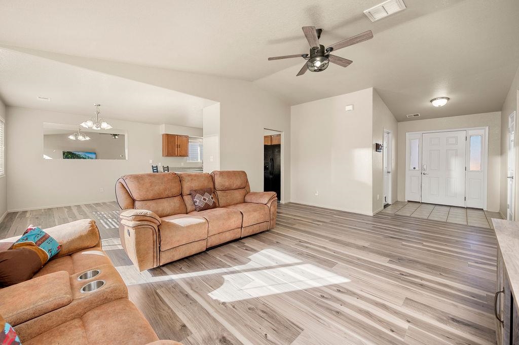 312 Catkin Street Fruita, CO 81521 - Photo 4 of 40 a view of a livingroom with a couch and a ceiling fan