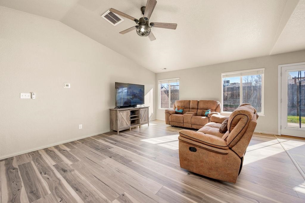 312 Catkin Street Fruita, CO 81521 - Photo 5 of 40 a living room with furniture and a flat screen tv