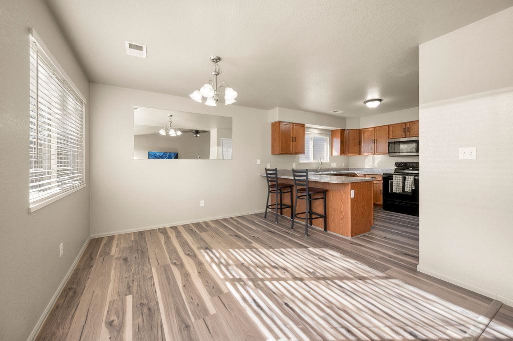 312 Catkin Street Fruita, CO 81521 - Photo 8 of 40 a kitchen with stainless steel appliances kitchen island granite countertop a sink cabinets and wooden floor