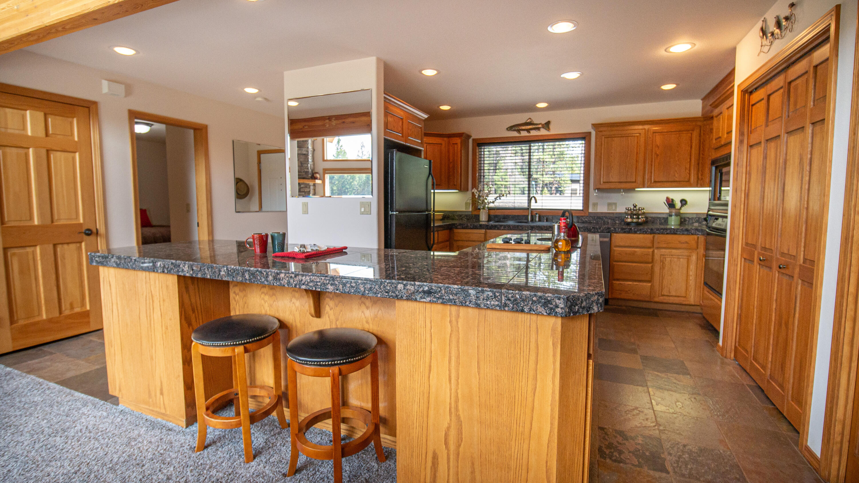 17079 Upland Road Bend, OR 97707 - Photo 8 of 32 Lots of counter space for prep & seating for casual meals. There is seating space on both sides of the counter. Pantry closet is perfect for food stuffs & service needs.