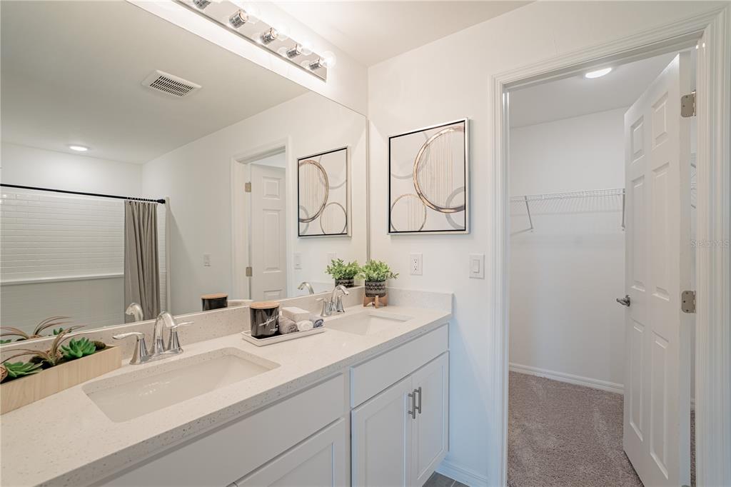 1603 Shilo Street Punta Gorda, FL 33980 - Photo 6 of 9 a bathroom with a double vanity sink mirror and shower