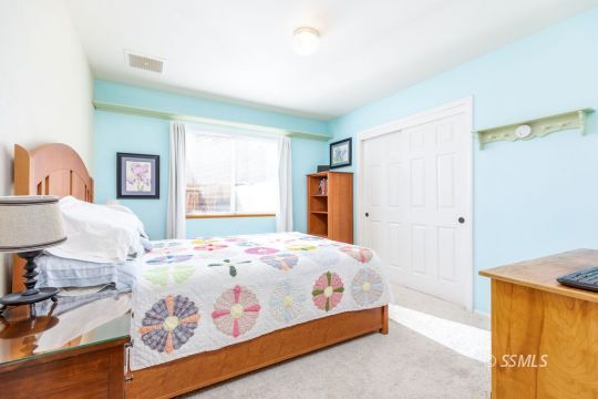 1217 Flora Way Ridgecrest, CA 93555 - Photo 29 of 39 a bedroom with a bed and a table in it