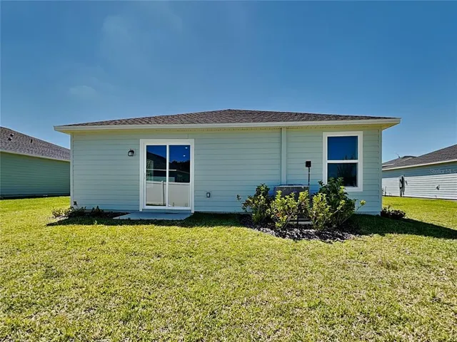 a front view of house with yard and outdoor seating