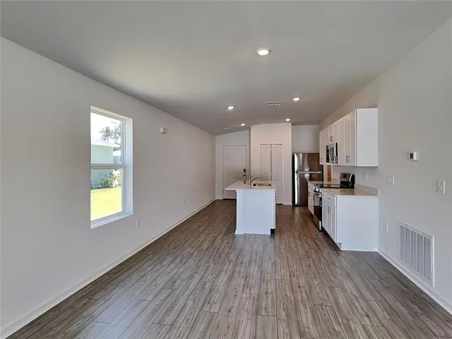a view of kitchen with cabinets and wooden floor