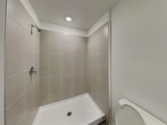a bathroom with a shower and a toilet