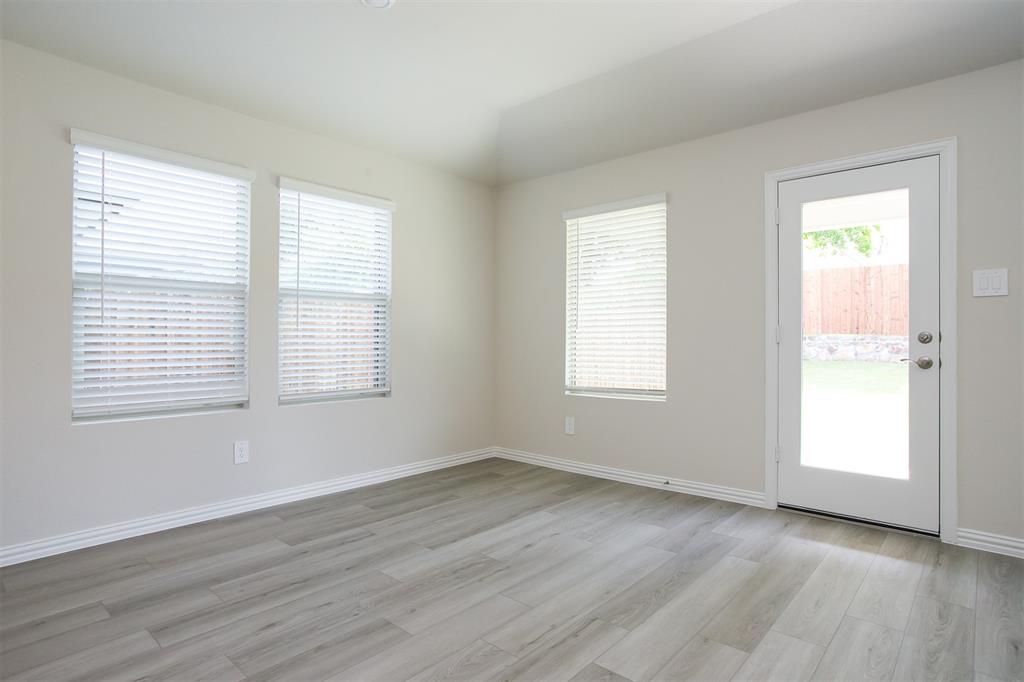404 Castle Road Sherman, TX 75092 - Photo 7 of 25 an empty room with wooden floor and windows